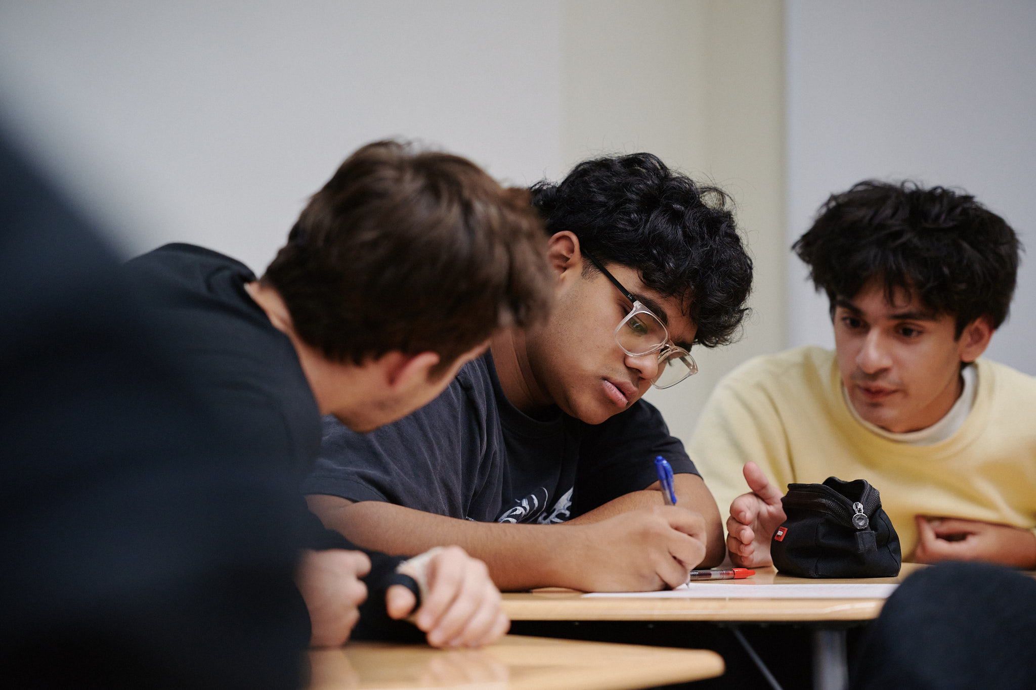 upper school student writing at desk