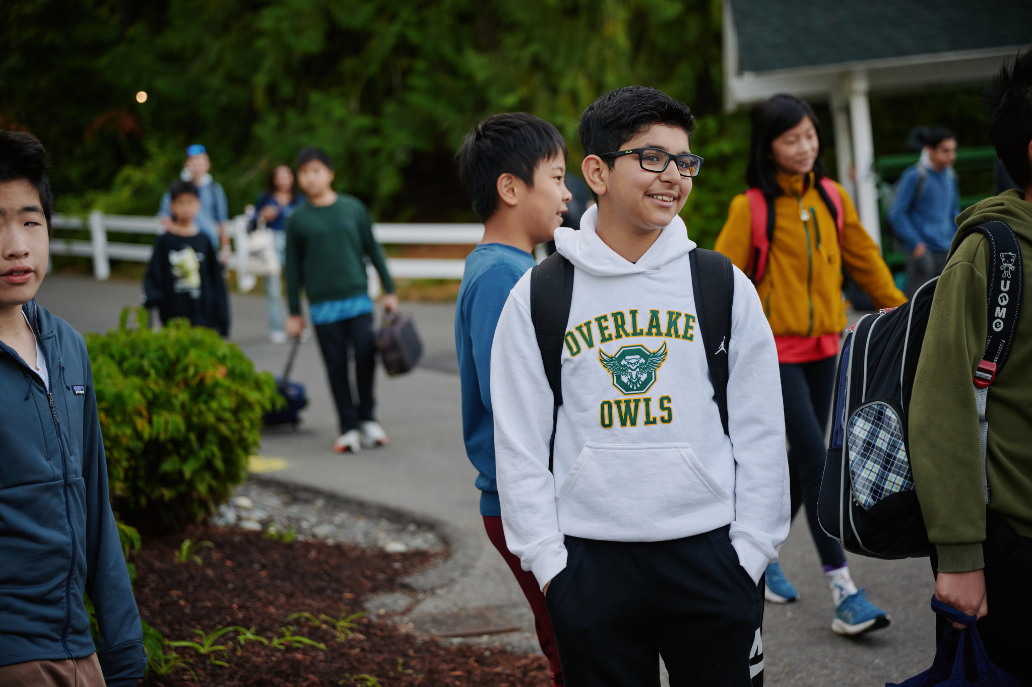student with Owls sweatshirt walking outside