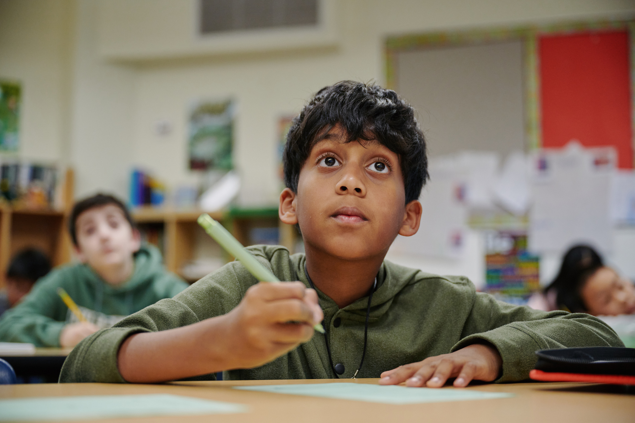 Middle schooler looking up from desk