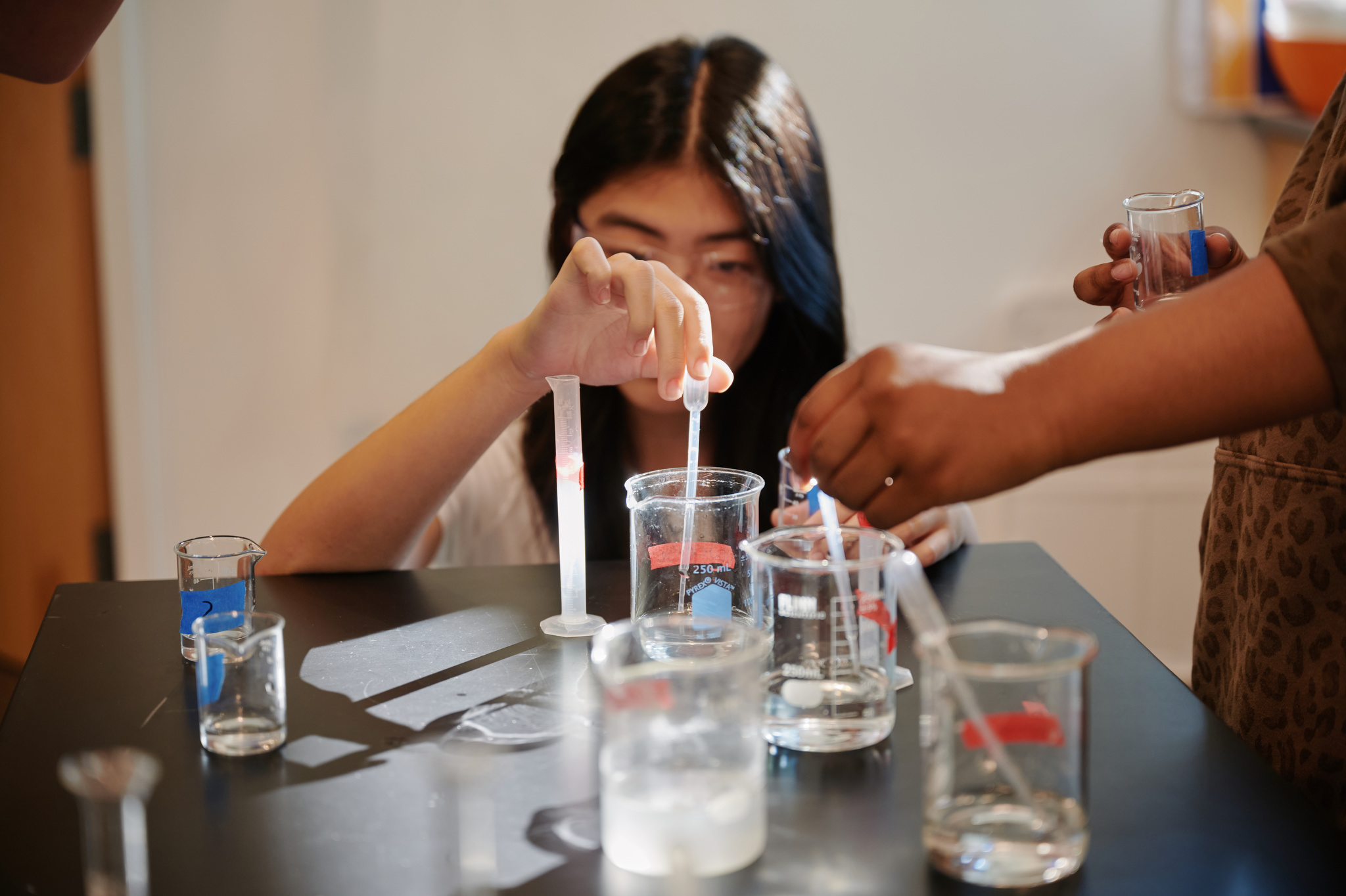girl with beaker in science class