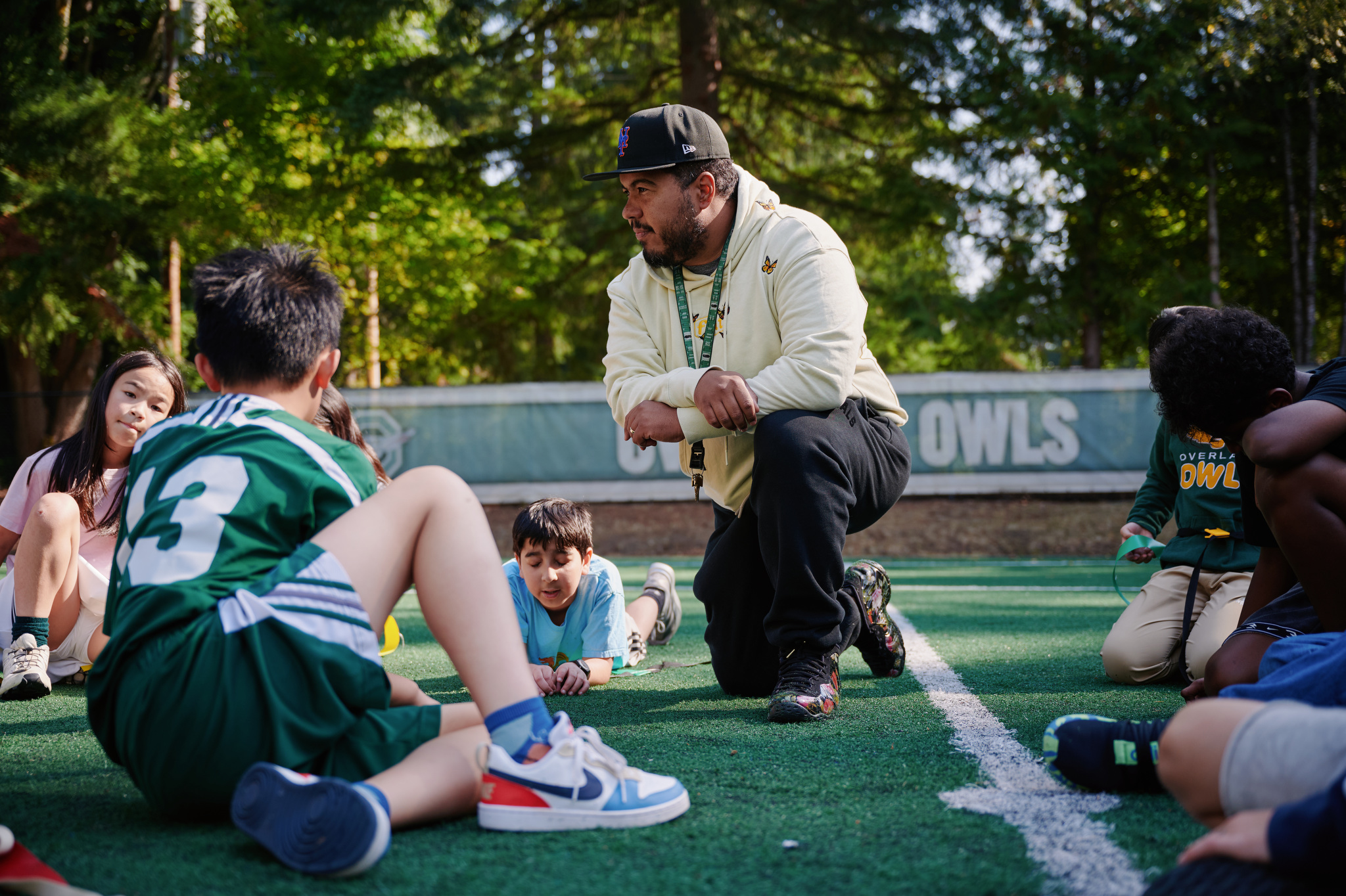 PE teaching talking to student on field