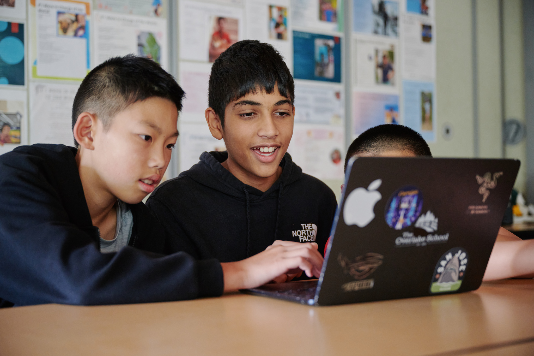 two boys looking at computer screen