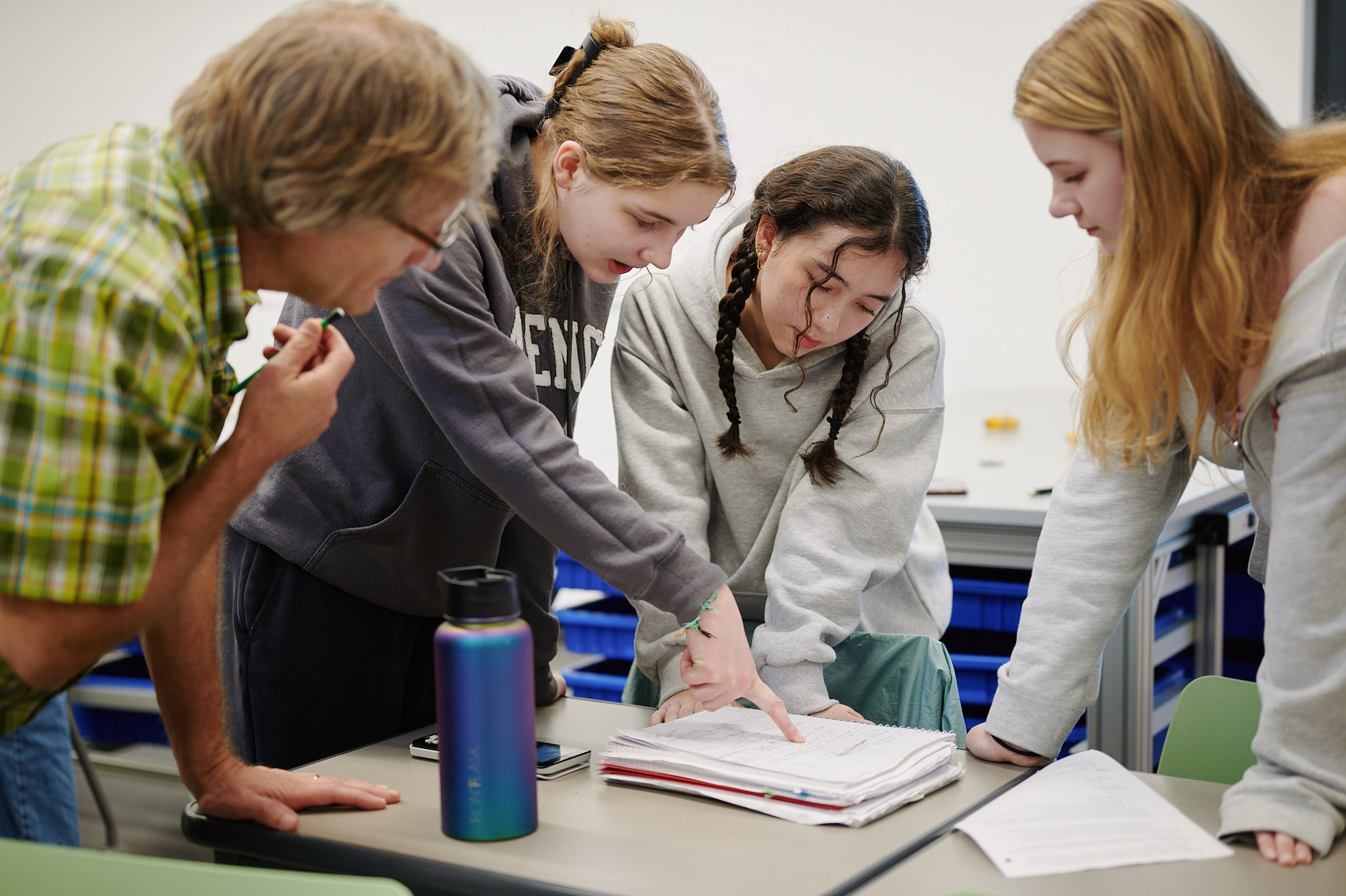 teacher looking at student's work