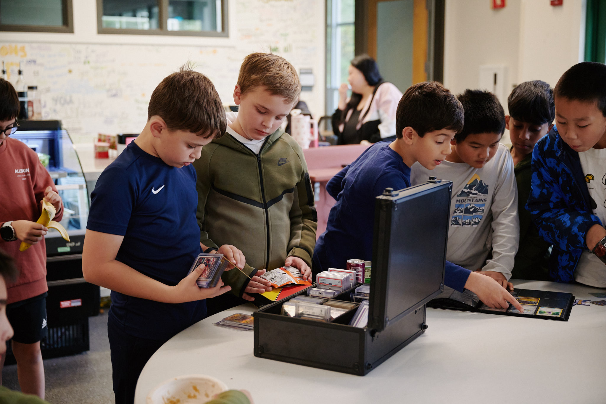 middle school students looking at playing cards