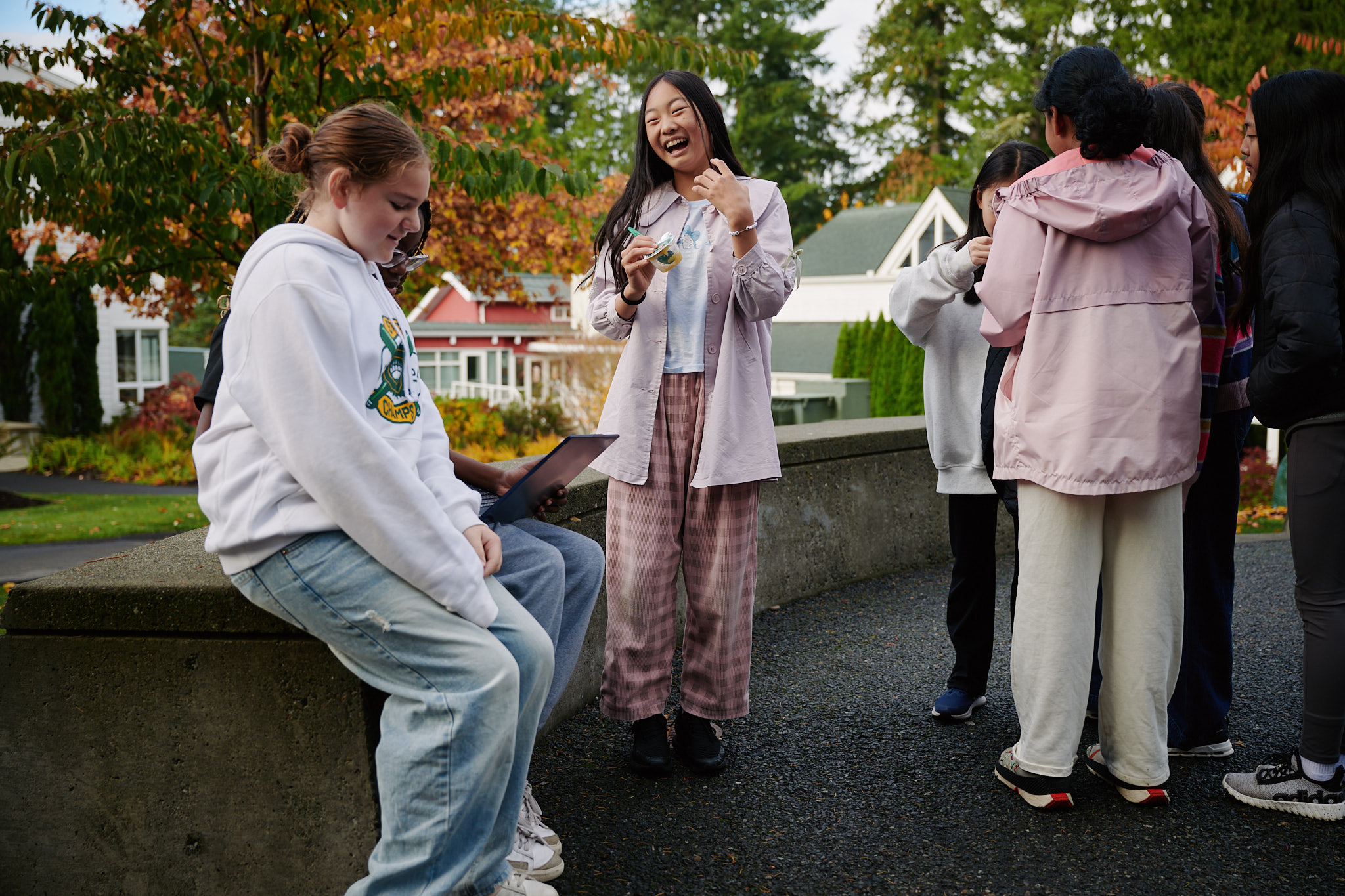 students sitting outside laughing