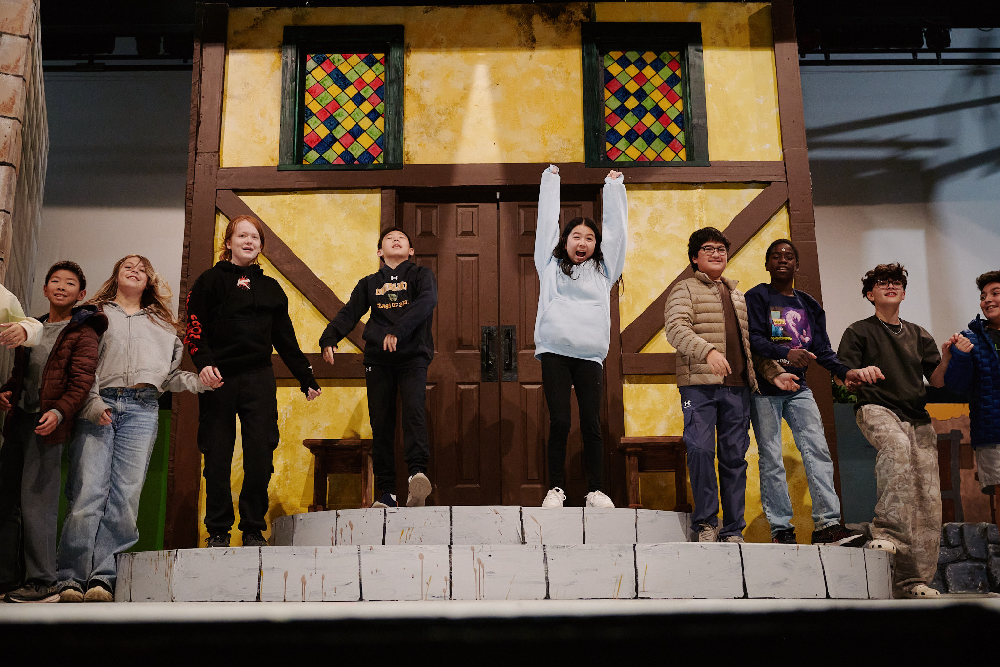 students rehearsing on stage