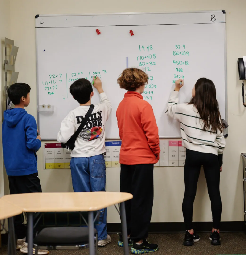 students doing mathwork at board