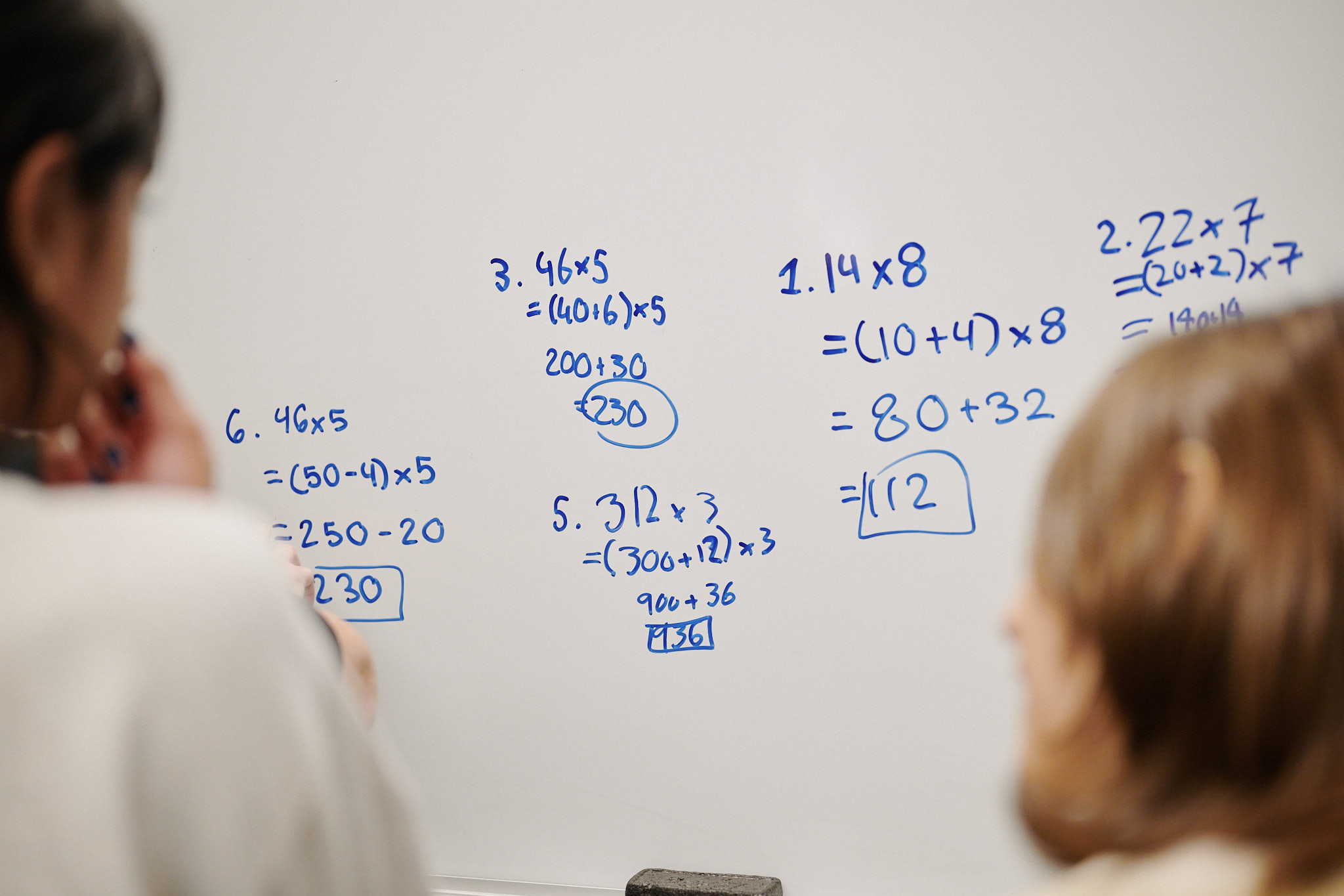 students doing mathwork at board