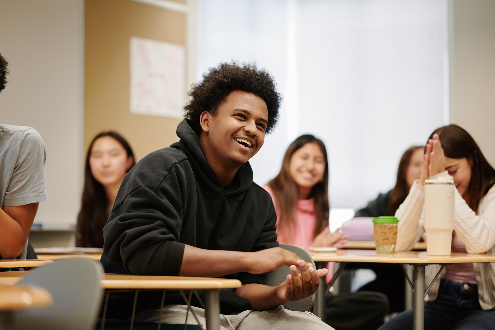 student smiling at desk