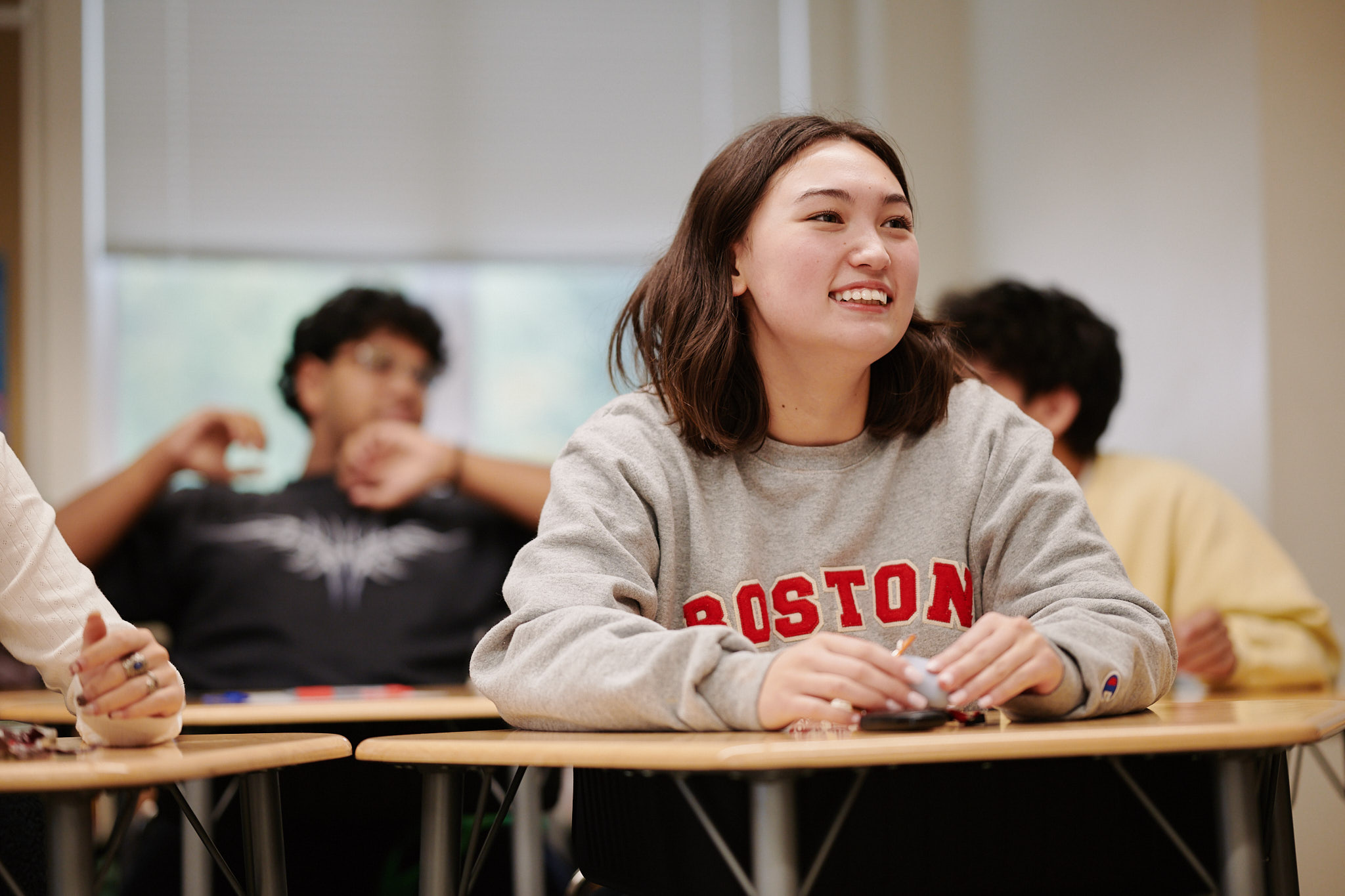 student smiling at desk