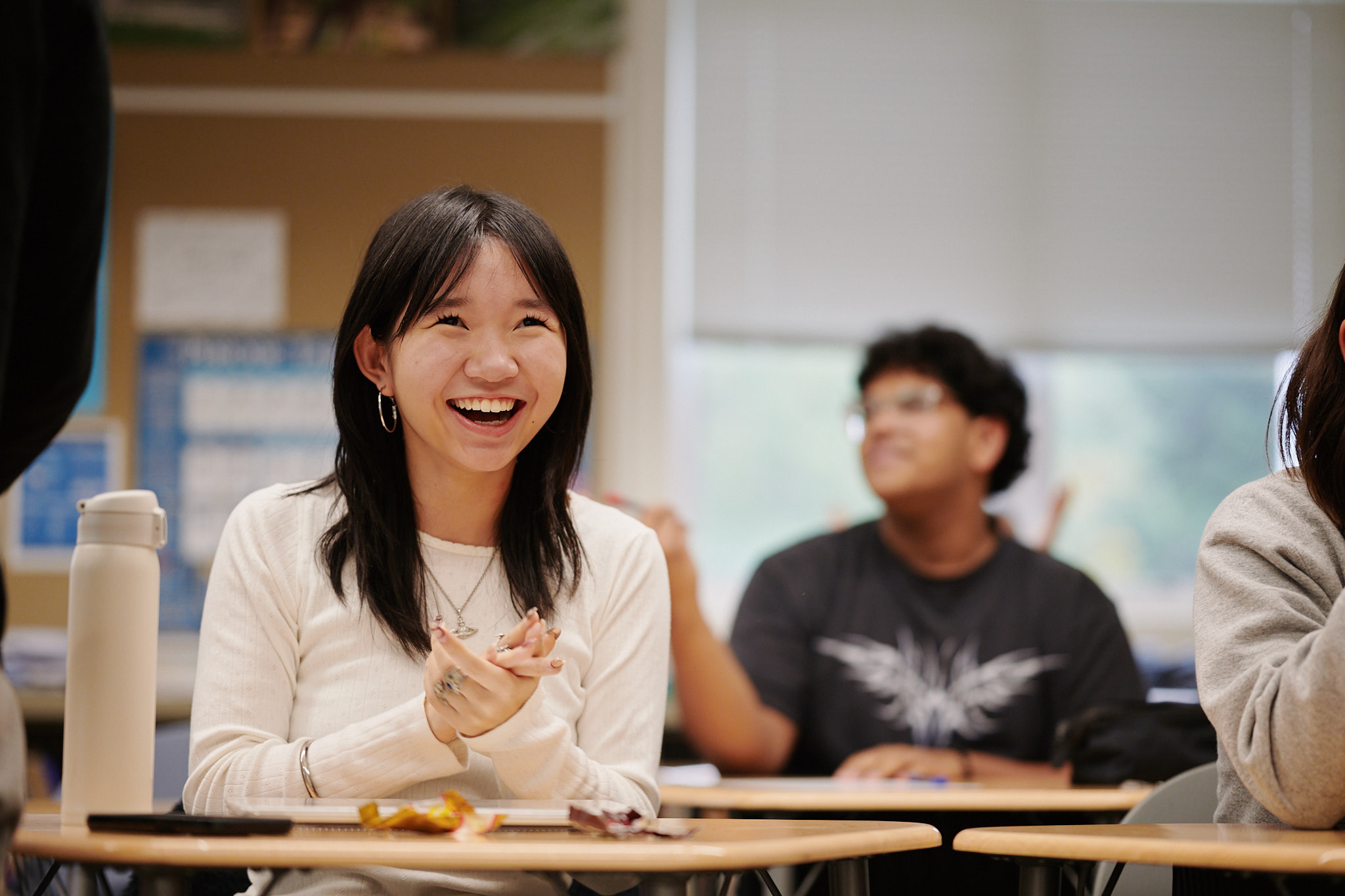 student laughing at desk