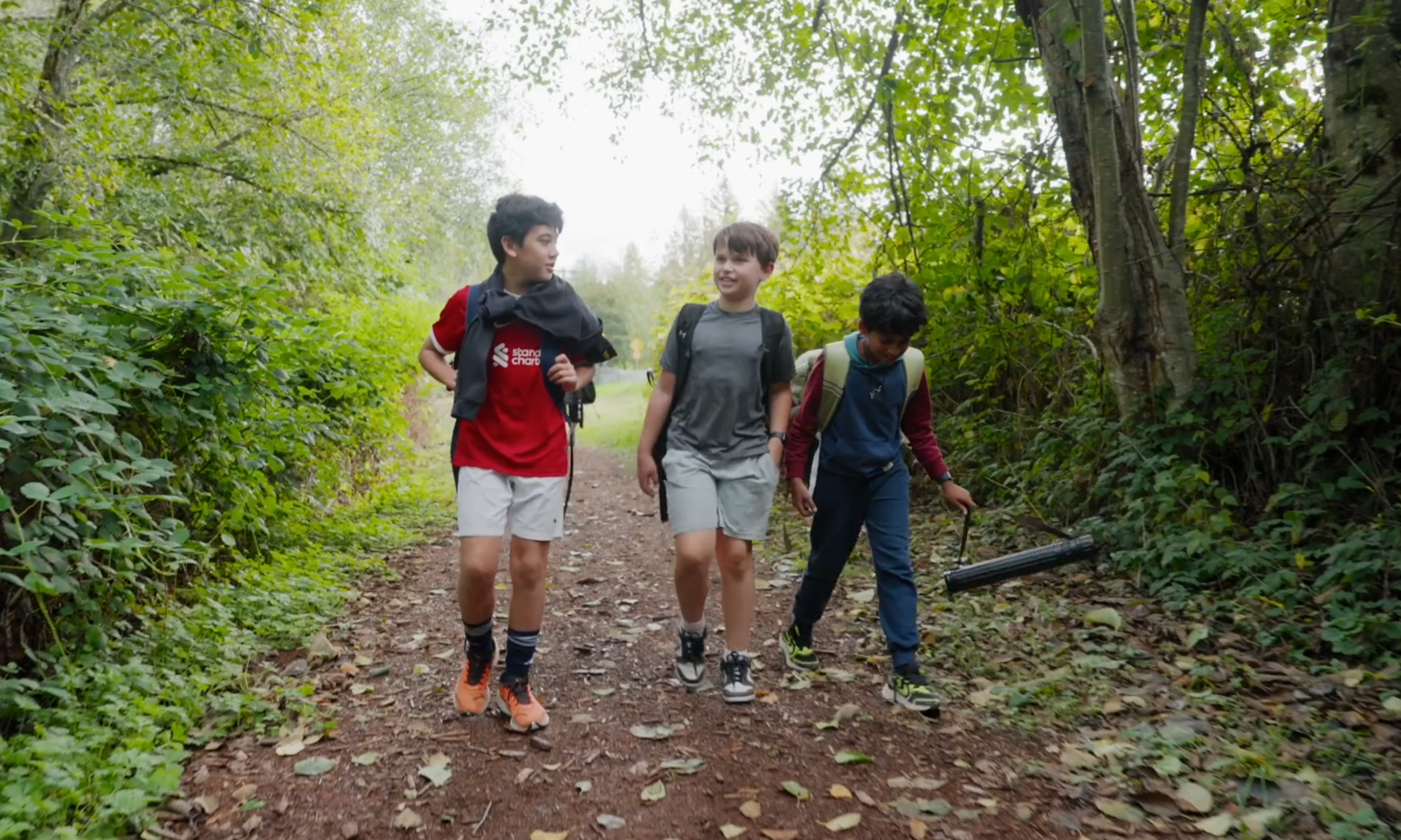 Three Overlake students walking a path