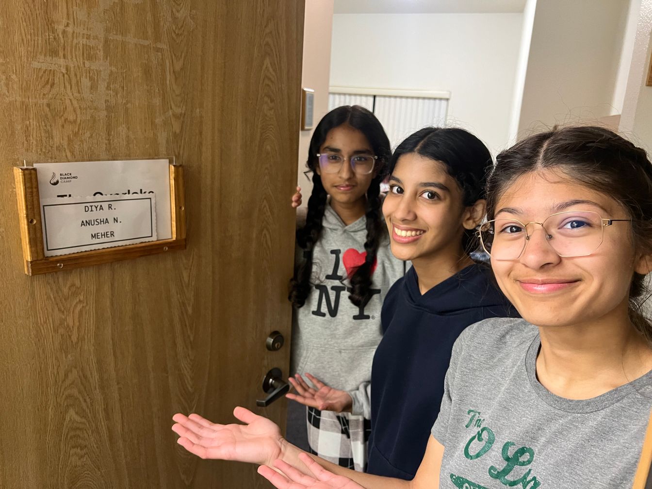 girls standing in front of dorm room