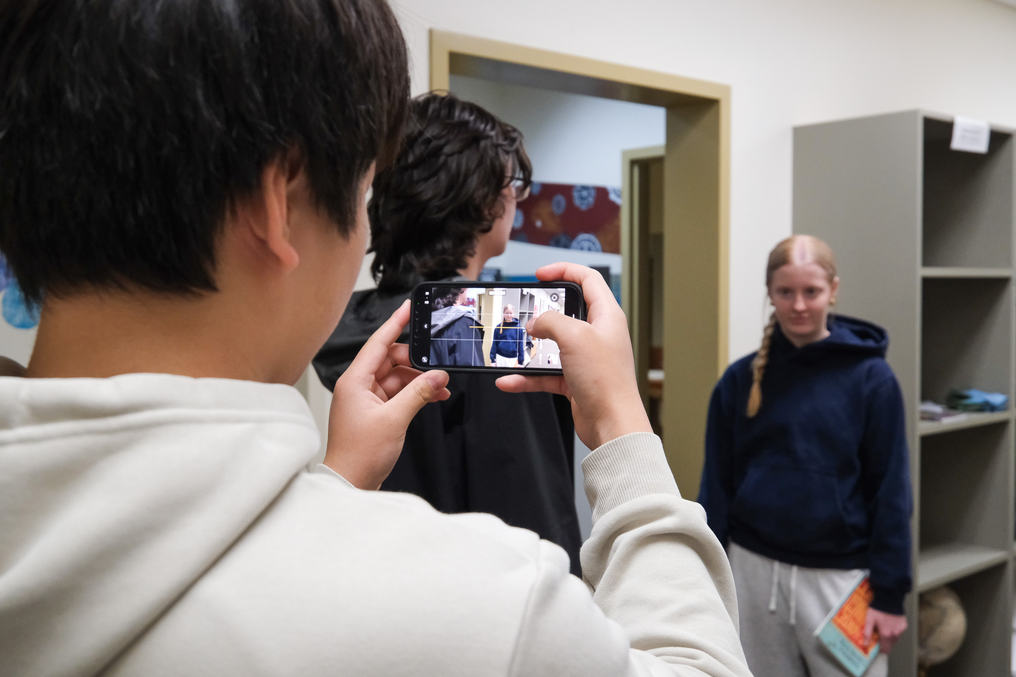 A student films a scene for the choir music video collaboration.