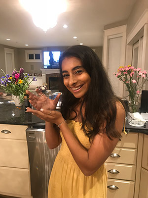 Alyssa J. holding her award and beaming