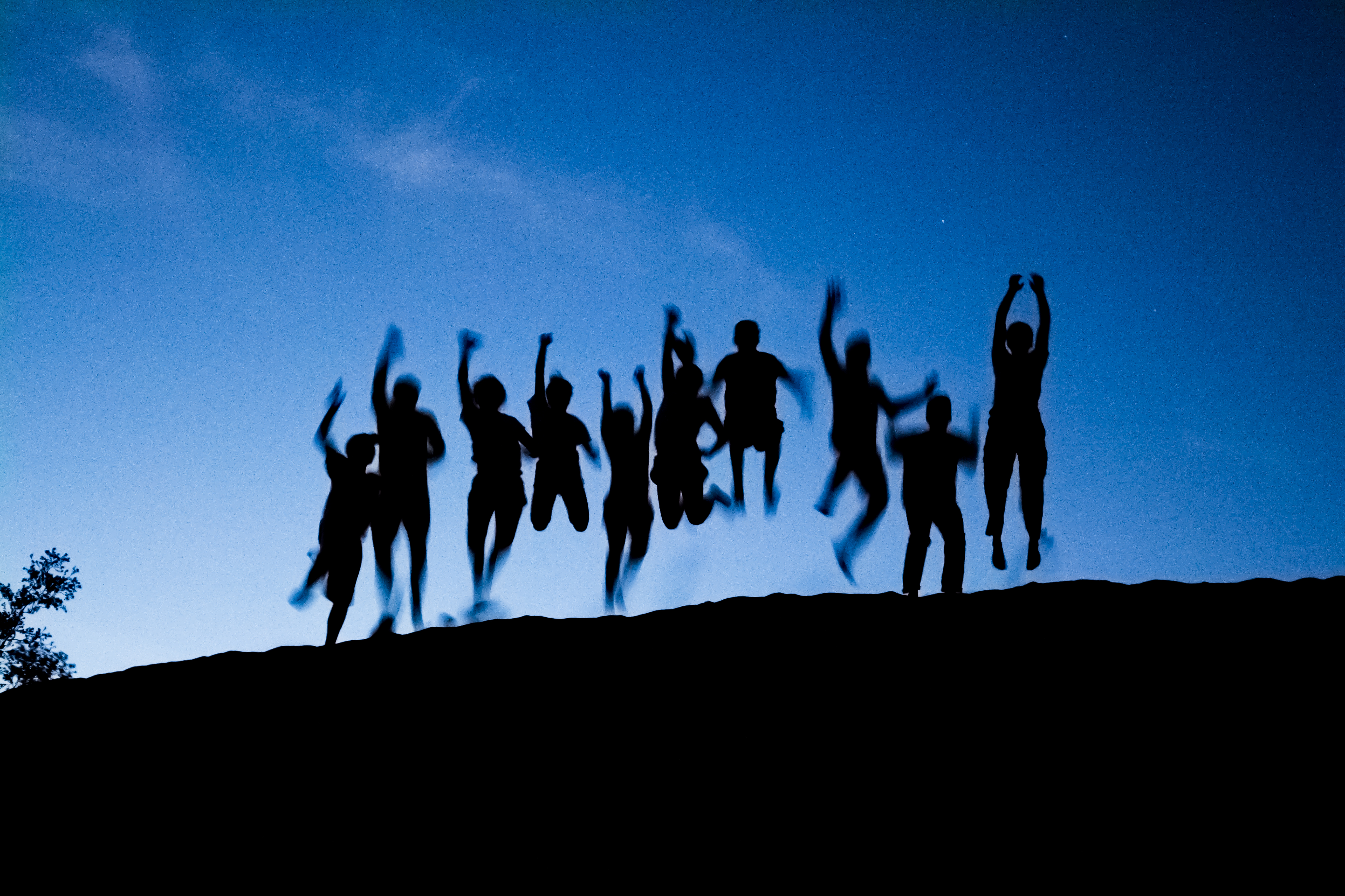 students jumping at the dunes