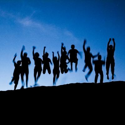 students jumping at the dunes