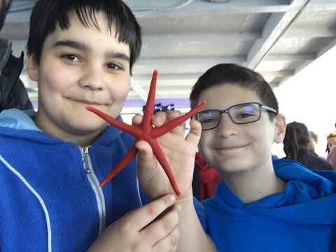 Students Hold up a Starfish