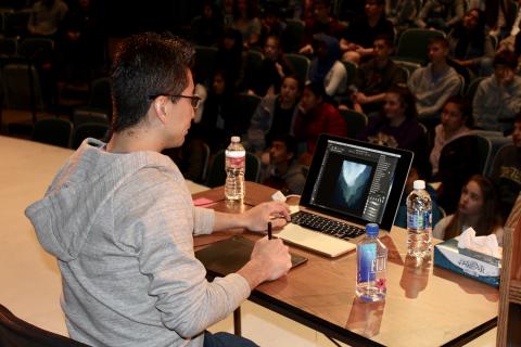 Kazu Kibuishi demonstrating computer drawing to students