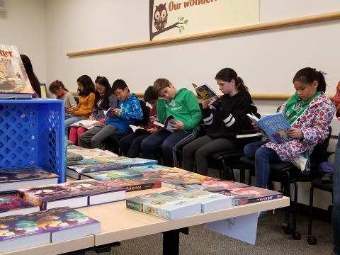 Students reading at bookfair