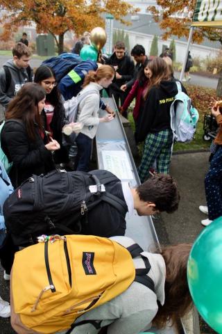 students sign beam