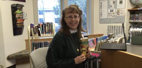 Rebecca Moore with booktalk books in library