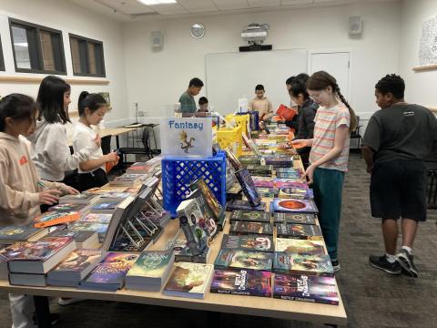 Students around books on table