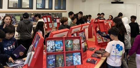 Students around books on table