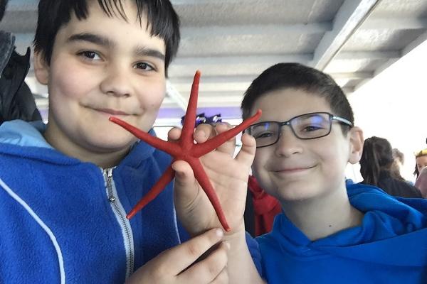 Students Hold up a Starfish