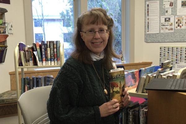 Rebecca Moore with booktalk books in library