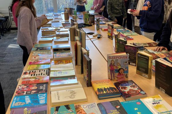 Students around books on table