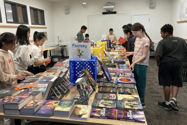 Students around books on table