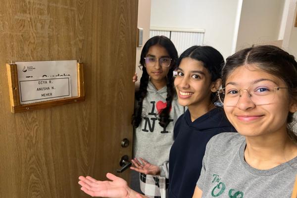 girls standing in front of dorm room
