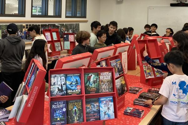 Students around books on table